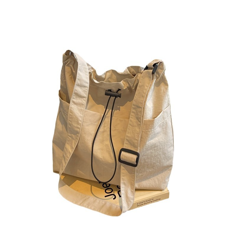Japanese-style large-capacity casual tote bag, simple, niche and versatile single-shoulder bag, fashionable commuting drawstring drawstring crossbody bag Item Picture
