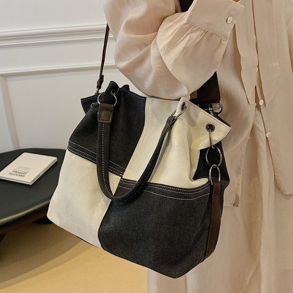 A new 2025 canvas bag for women, with a large capacity, artistic and retro style, and a unique texture for commuting. It is a hand-held shoulder crossbody bag full figure
