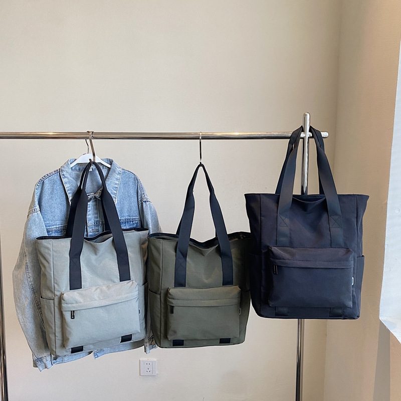 Large-capacity casual and simple single-shoulder bag, a hand-held cloth bag for college students to attend classes, a commuting bag for work, and a storage bag for tablet computers details Picture
