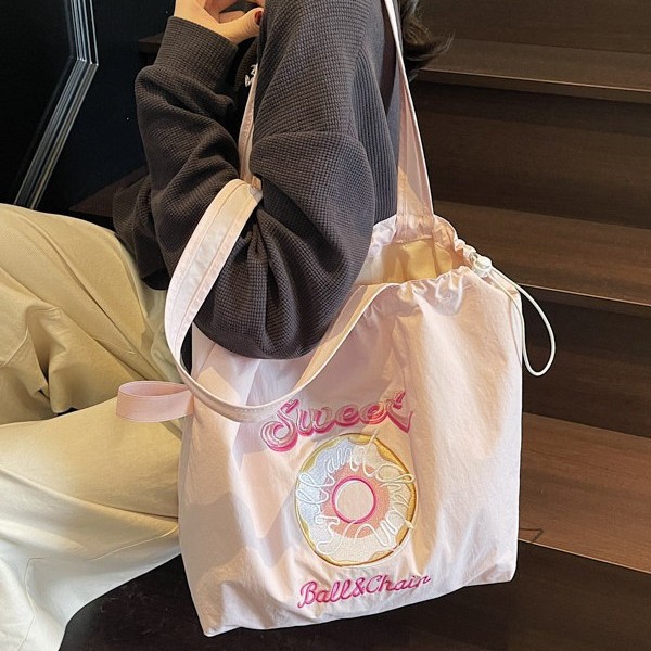 Japanese-style donut embroidery nylon shopping bag, simple and versatile for commuting, large-capacity single-shoulder bag, trendy and lightweight casual bag Application Scenario