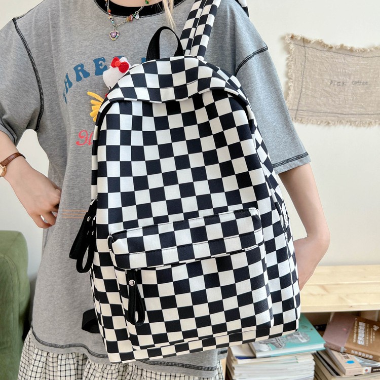 Wholesale of new minimalist and ultra-light black and white checkered canvas bags for girls, large-capacity backpacks for primary and secondary school students full figure