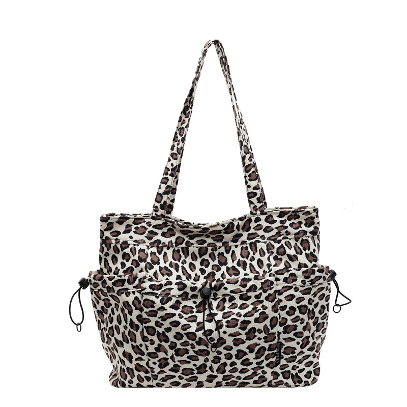 A niche leopard-print canvas tote bag for women's casual commuting, with a large capacity and a fashionable new style, a stylish single-shoulder bag Item Picture