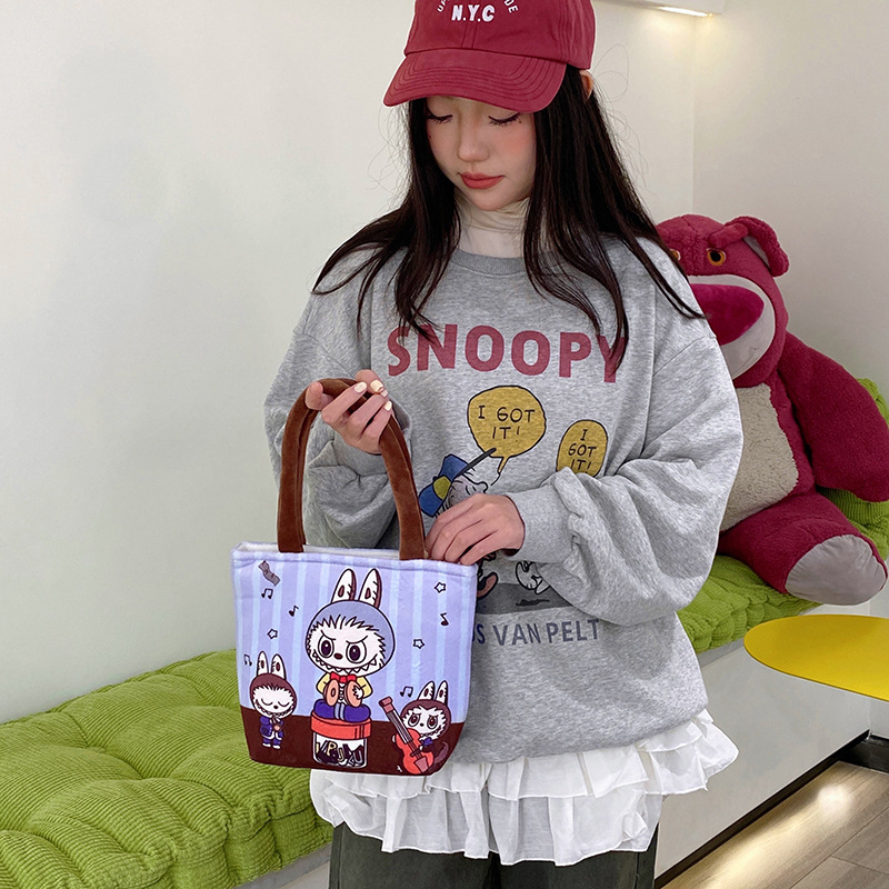 A new cartoon multi-pattern printed handbag with a Japanese girl's heart, a hand-held storage bag with a zipper Application Scenario