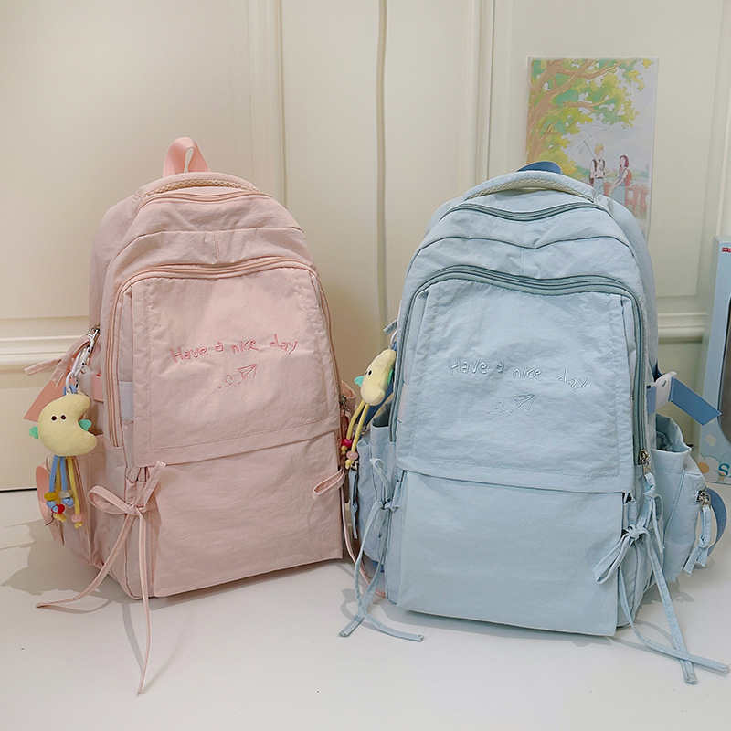 New casual backpacks for boys and girls, large-capacity and low-load backpacks, simple letter schoolbags for high school and junior high school students, cross-border full figure