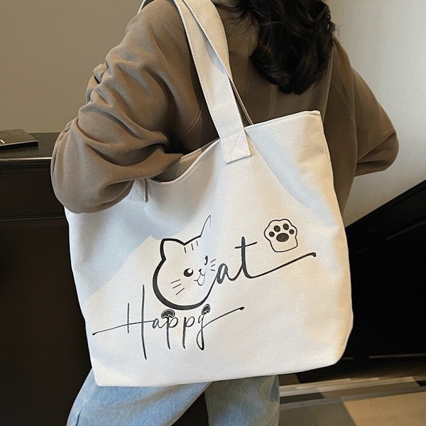 Cute cat-printed large-capacity, simple and fashionable schoolbag, fashionable and individual hand-held shoulder new class bag details Picture