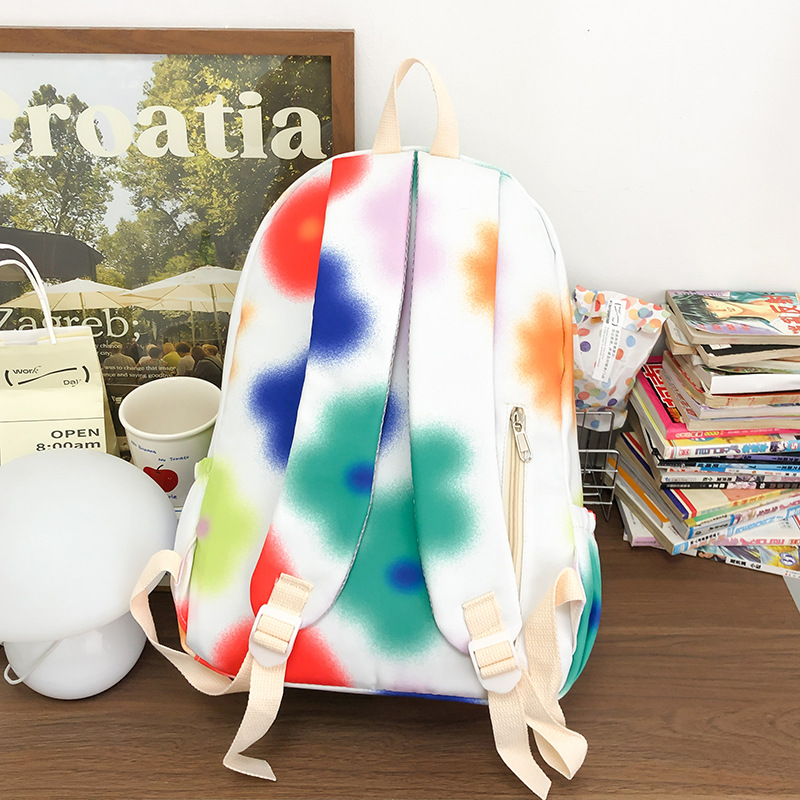Cute flower junior high school student schoolbag, large-capacity tie-dyed colorful commuting backpack, niche design college student backpack Application Scenario