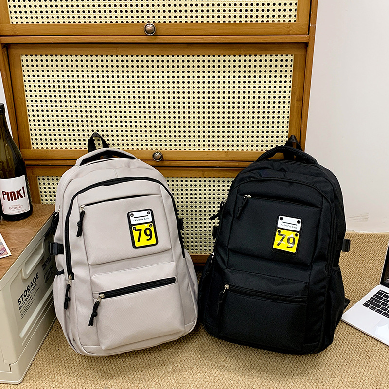 New solid-color casual backpack, lightweight schoolbag for junior high school, senior high school and college students, durable, load-reducing and spine-protecting study bag full figure