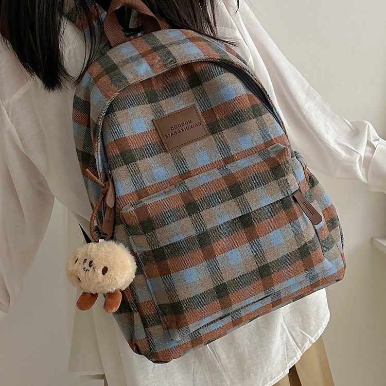 This is a new large-capacity backpack with a checkered pattern for autumn and winter. It features a cute puppy and a versatile student bag full figure