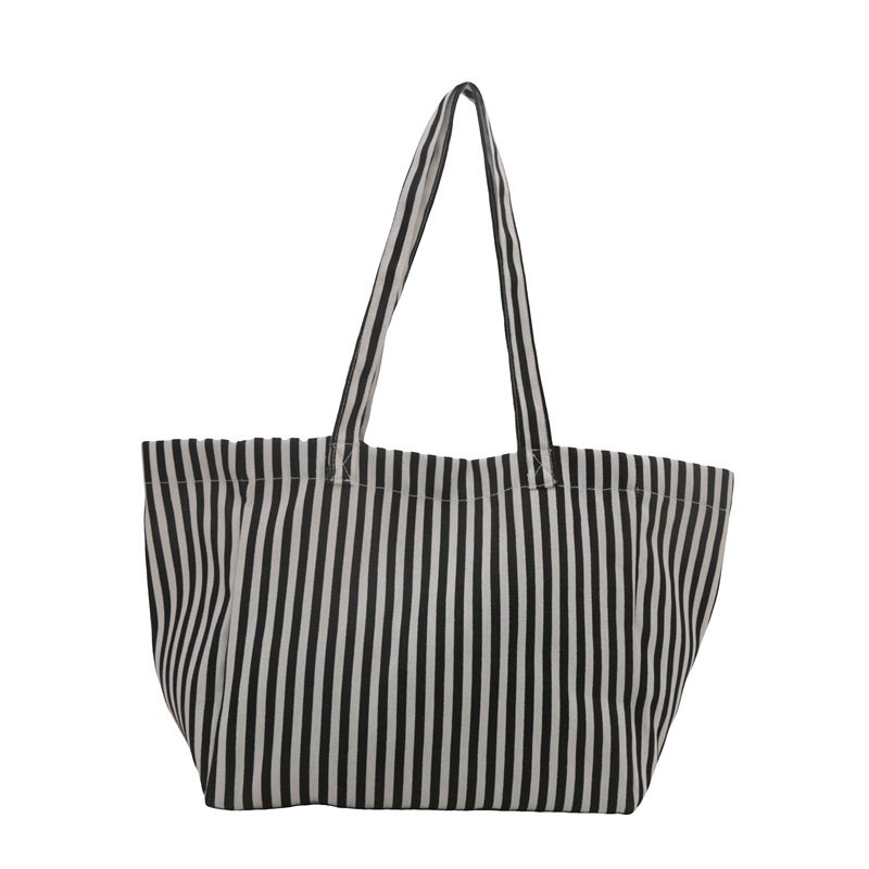 A niche design sense commuter striped canvas tote bag for women, a new 2024 large-capacity casual hand-held shoulder bag Item Picture