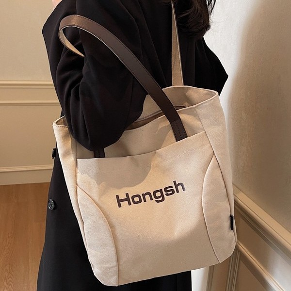Korean-style fashionable casual color-blocking bag with letter print, high-end hand-held tote bag, color-blocking versatile single-shoulder bag full figure