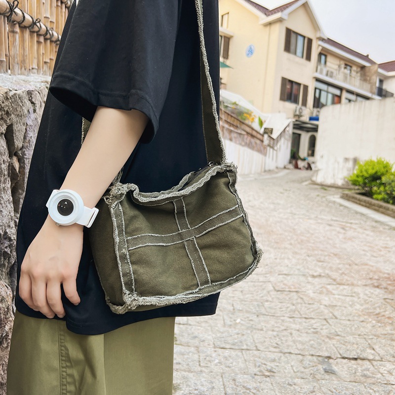 Japanese-style washed canvas bag for women, solid color, casual and niche single-shoulder crossbody bag, with unique fringed stitching and artistic mobile phone bag details Picture