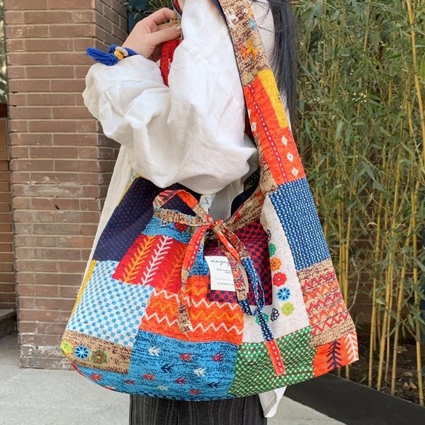 A new 2025 vintage ethnic style single-shoulder crossbody bag with color-blocking and double-sided Bohemian fabric full figure