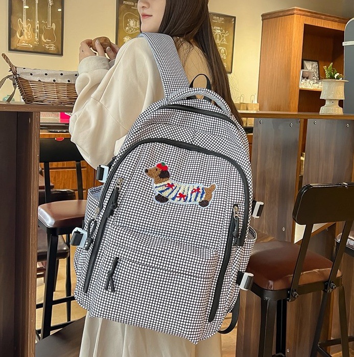 Schoolbag for female college students, a niche design backpack, a large capacity backpack with a checkered cartoon puppy for junior and senior high school students full figure