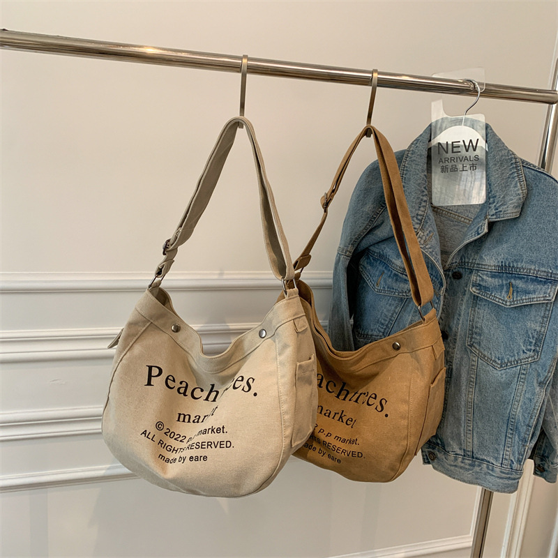 2022 New large-capacity canvas bag for women, simple single-shoulder bag with letter print, laid-back style, retro Korean style women's bag Specification drawing