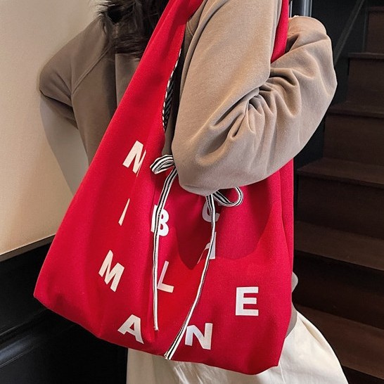 Large-capacity color-blocking striped double-sided canvas bag, 2025 new style color letter bow shopping bag, single-shoulder bag Application Scenario