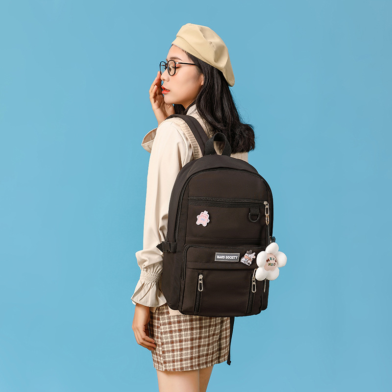 A new multi-color, large-capacity, lightweight backpack for girls in the middle school, a nylon Korean-style backpack, has been designed full figure