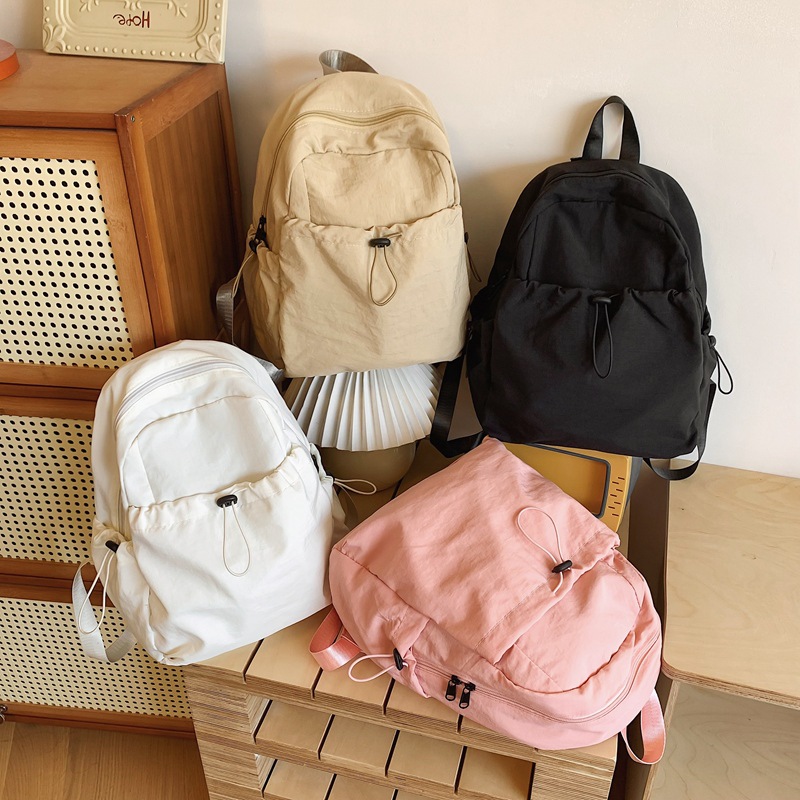 A new pink large-capacity, high-end casual commuting bag with a simple nylon travel backpack in the style of a cross-border college full figure