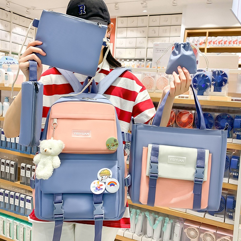 Wholesale of new casual canvas backpacks for primary and secondary school students, large-capacity Korean version backpacks for girls, and hand-held tutorial bags full figure