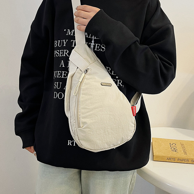 This Japanese-style simple nylon crossbody bag is a large-capacity sportswear and casual chest bag for women. When commuting, you can pair it with a shoulder bag full figure