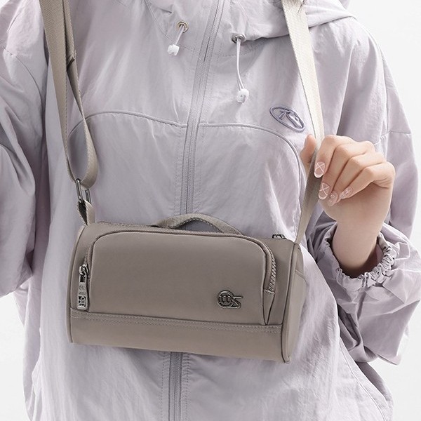 This is a new design for women's bags in autumn. The waist bag is simple and solid in color, cylindrical. It's a trendy, cute and fashionable single-shoulder crossbody bag for little girls details Picture