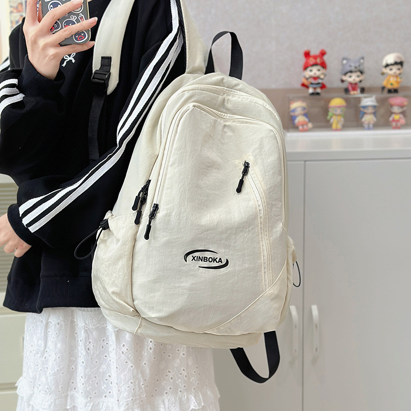 A lightweight college student backpack from a trendy Japanese Instagram brand, with a high level of appearance, simple and solid color design, and a versatile computer backpack full figure