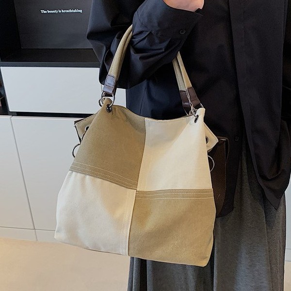 A new 2025 canvas bag for women, with a large capacity, artistic and retro style, and a unique texture for commuting. It is a hand-held shoulder crossbody bag details Picture
