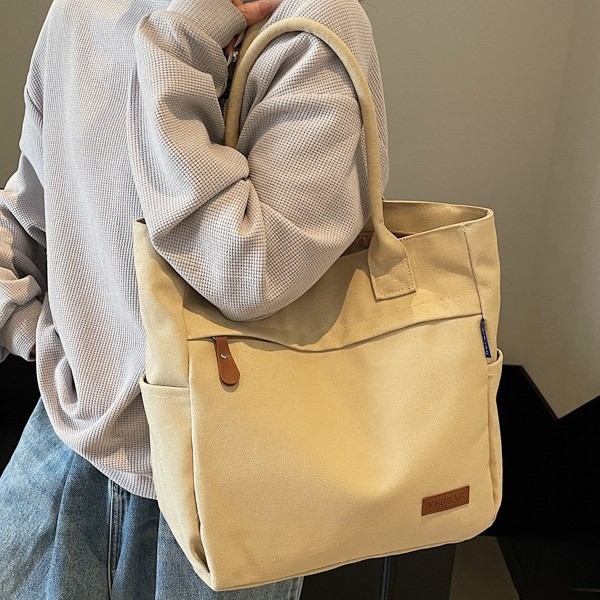 Spring and summer women's versatile tote bags, large-capacity canvas bags, solid-color design hand-held shoulder bags, trendy full figure
