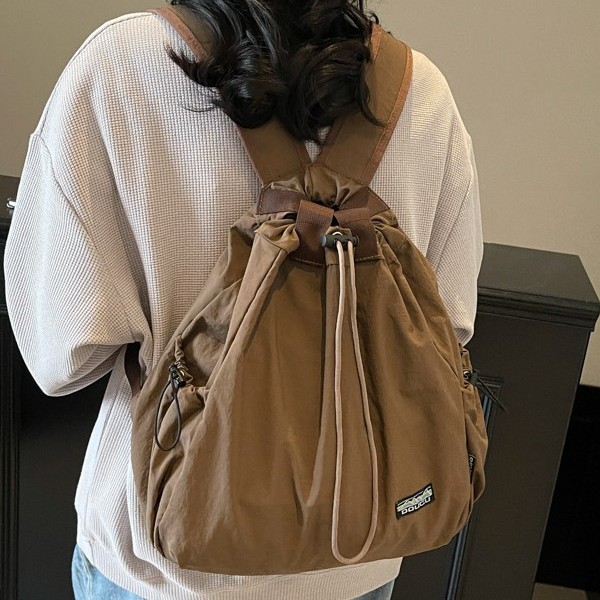 New Spring 2025 tapered casual single-shoulder bag with large capacity, suitable for both men and women, Korean version student backpack full figure