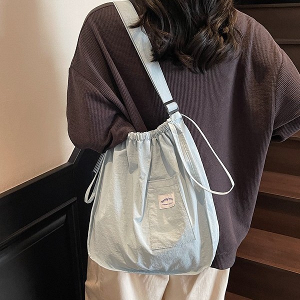 The 2025 new lightweight handbag is a small and exquisite cloth bag with a solid color and simple drawstring. It is a student portable single-shoulder bag details Picture