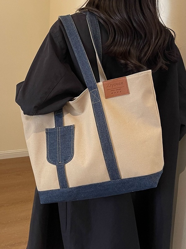 A new large-capacity tote bag for women, a color-blocking canvas bag, a casual and simple hand-held shoulder bag, and a fashionable underarm bag details Picture