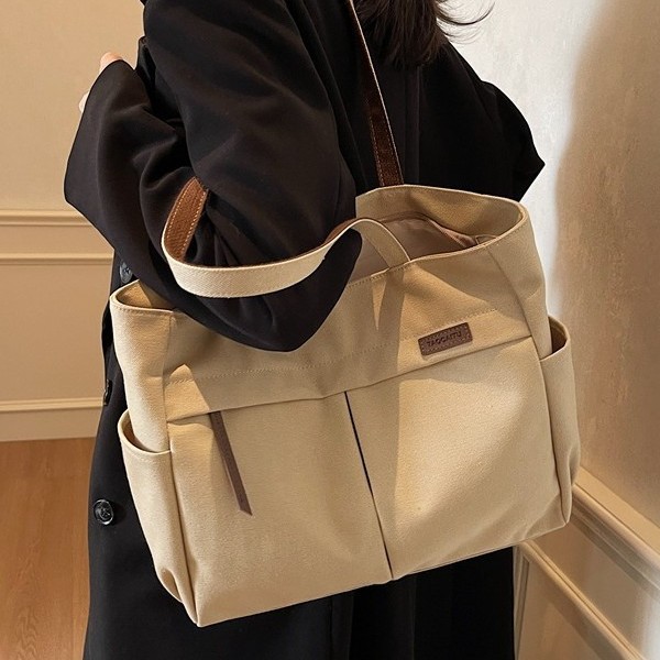 Japanese and Korean artistic and simple hand-held shoulder canvas bag for women, a new Spring/Summer 2025 trendy and versatile commuter tote bag full figure