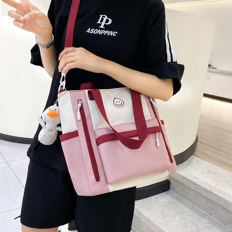 Color-blocking casual large-capacity tutorial bag, book bag for junior and senior high school students, hand-carried bag for class, high appearance level crossbody bag for girls details Picture