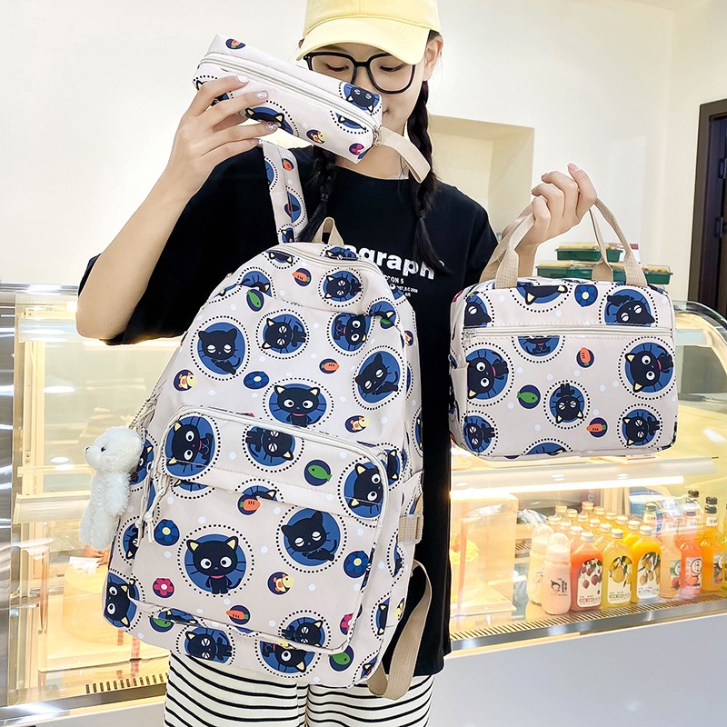 A three-piece set of cute cat backpacks for girls in grades three to six, a large-capacity cartoon travel backpack full figure