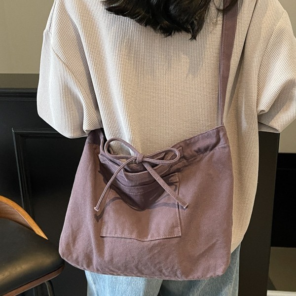 Solid-color canvas crossbody bag for women, bow-designed postman bag, large-capacity single-shoulder bag for women, and schoolbag for students details Picture