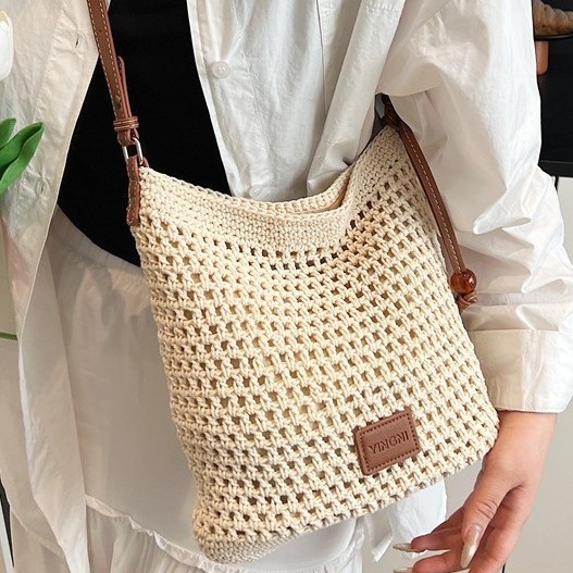 A new Korean-style, stylish and casual handcrafted grid eye hollowed-out knitted large-capacity shopping bag for single-shoulder crossbody women full figure
