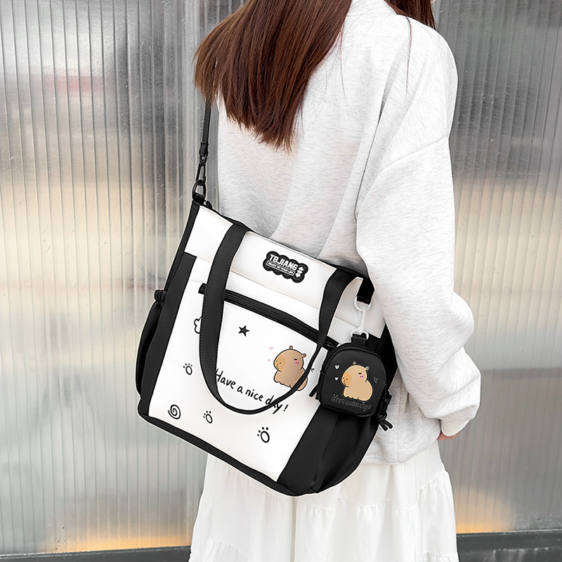 Large-capacity cartoon school-style single-shoulder bag for female primary school students to carry books for class tutoring. High appearance level student crossbody bag full figure
