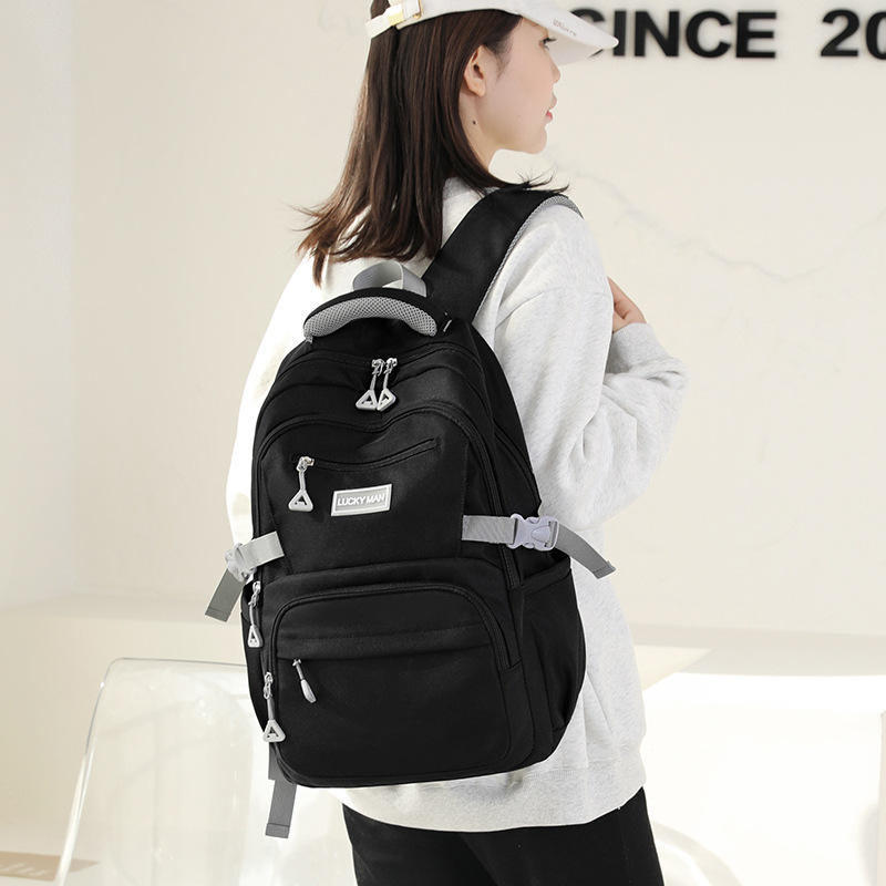 This is a new 2024 model of water-resistant backpack for students in grades three to six. It is a large-capacity, simple travel backpack details Picture
