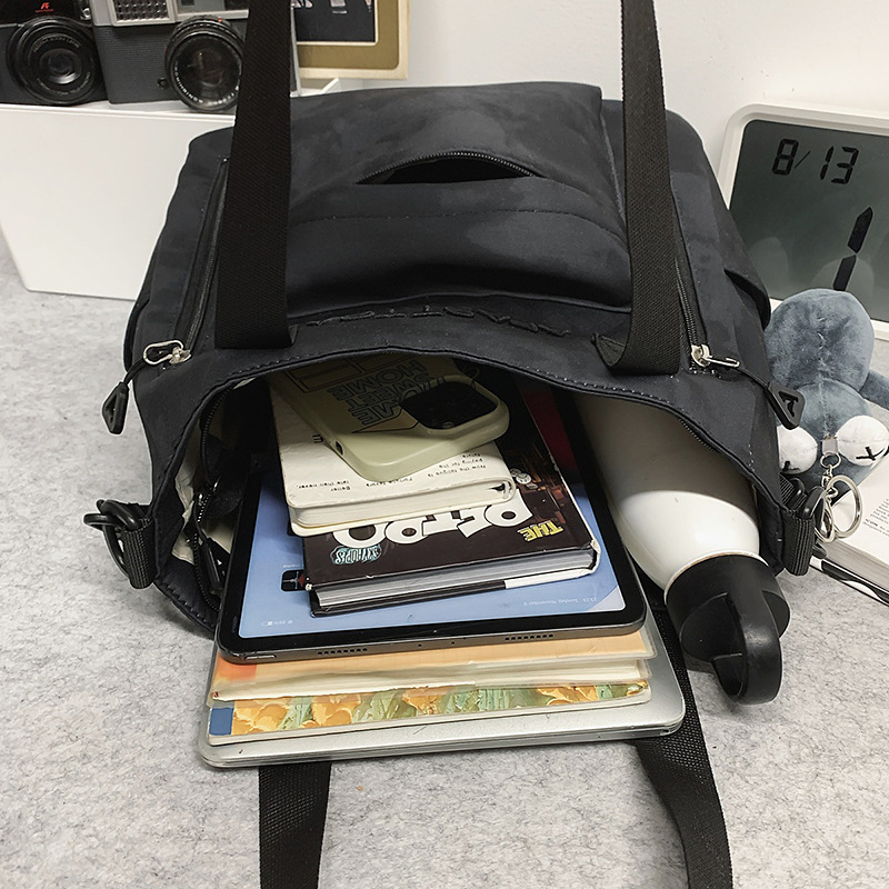 New fashionable schoolbag, dirt-resistant, dark color, niche and laid-back style, single-shoulder bag, graffiti, lightweight, commuting couple schoolbag Application Scenario
