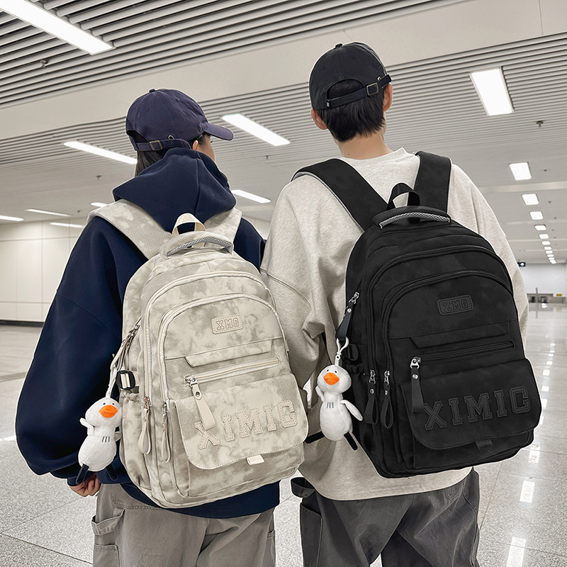 The new men's large-capacity, trendy and cool couple's casual travel backpack is sturdy and durable. It is a backpack for teenagers and students full figure