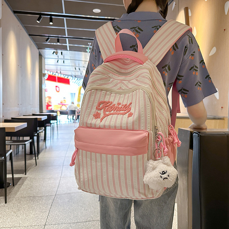 The new forest-themed ins high-appearance-level fresh and sweet candy-colored striped backpack is a large-capacity backpack for junior and senior high school students full figure
