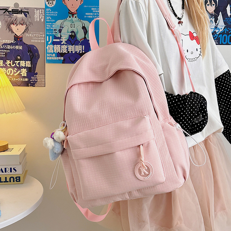 A fresh and versatile schoolbag with a unique Korean ins school style for spring, featuring a high level of appearance. It's a small backpack for girls to go shopping full figure
