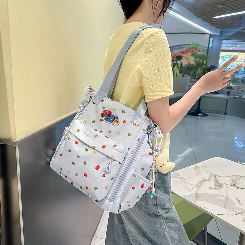 A new high-appeal, fresh and cute printed backpack for students, a casual, simple, lightweight and versatile large-capacity crossbody bag full figure