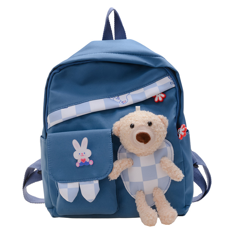 The new boys' and girls' schoolbags are cute and versatile. They are cartoon children's checkered bear dolls and backpacks Item Picture