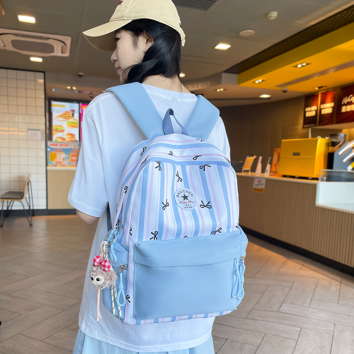 A new Japanese-style backpack with a high aesthetic level, fresh and sweet bow stripes, and a color-matched lightweight backpack for junior and senior high school students full figure