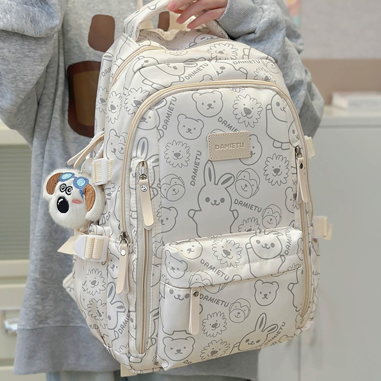 A new style of simple and cute graffiti schoolbag for boys and girls, a trendy large-capacity student backpack for junior high school and senior high school Application Scenario