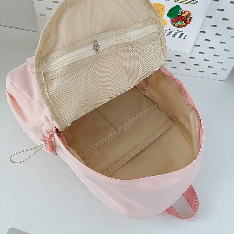 The 2025 new solid-color Ins-style backpack in Korean style is versatile and has a high level of appearance. It is a simple and large-capacity student schoolbag Application Scenario