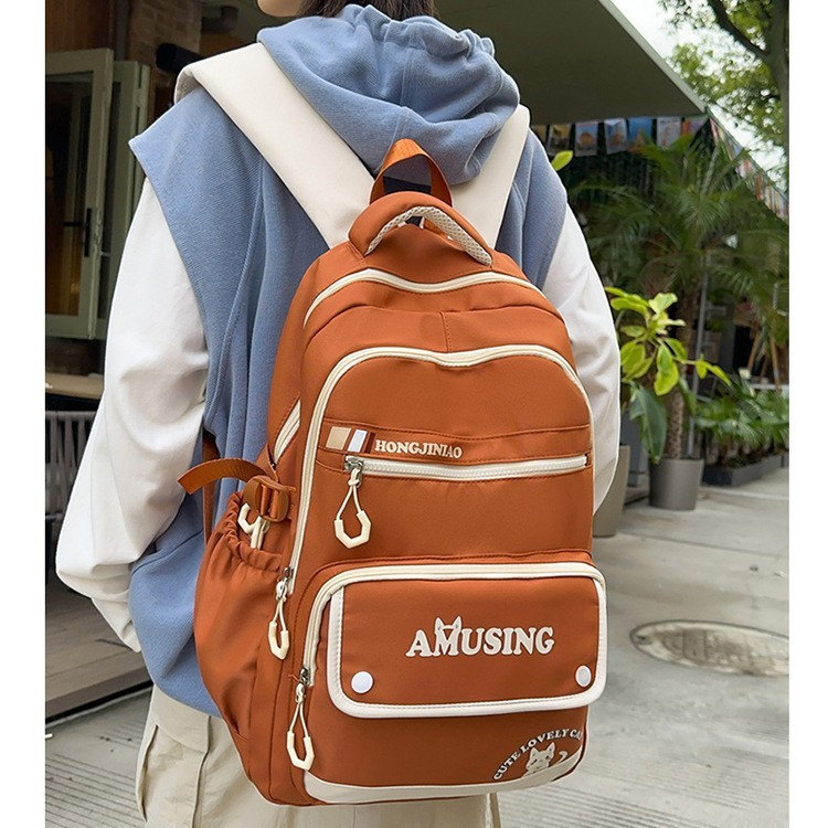 A new Korean-style college student couple casual backpack with a high appearance level. It is a multi-layered backpack for teenagers and students details Picture