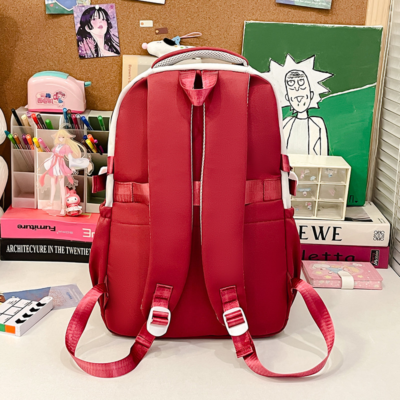 Color-blocking cartoon large-capacity multi-compartment schoolbag, versatile high appearance level backpack, simple and casual travel bag for going out Application Scenario