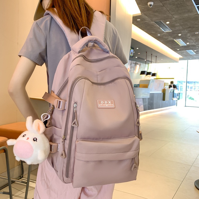 New schoolbag for female college students, solid-color large-capacity backpack, multi-layered and sturdy backpack for junior and senior high school students full figure
