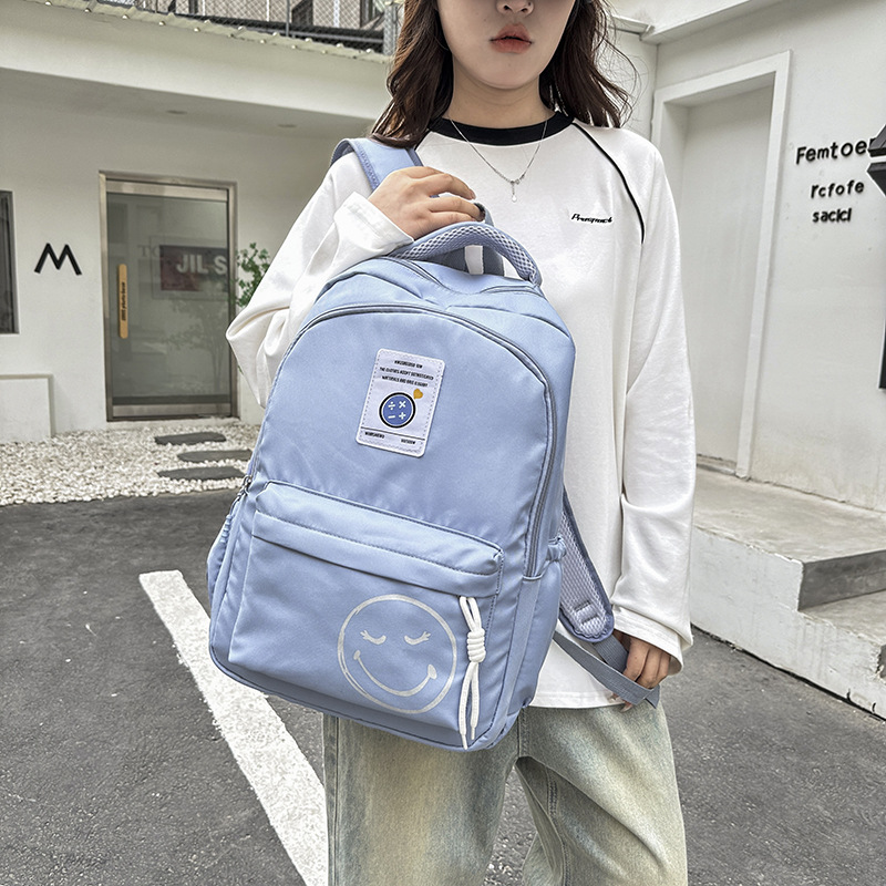 The 2024 new style of fashionable and simple backpacks for trendy boys and girls, large-capacity schoolbags for students, and cute smiling face printed backpacks Application Scenario